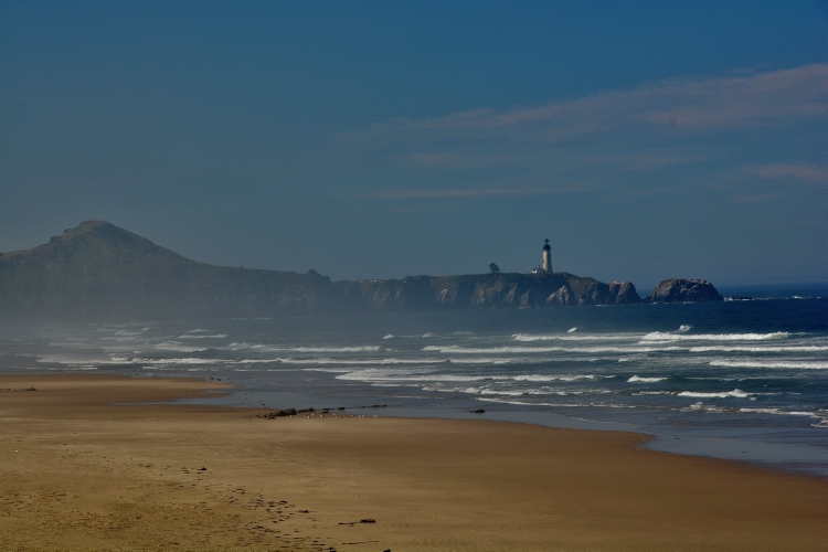 lighthouse in distance over the water